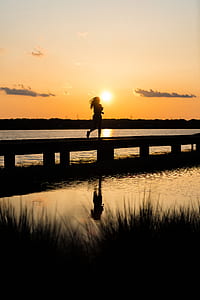 woman running on wooden dock thumbnail