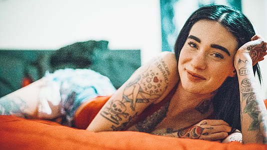 woman lying on orange bed thumbnail