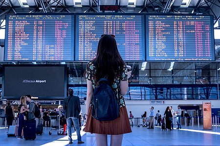 woman in green and black short-sleeved and brown mini skirt inside airport thumbnail