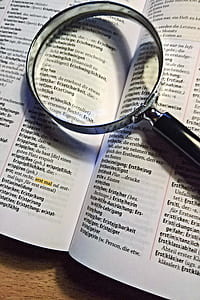 black magnifying glass on dictionary thumbnail