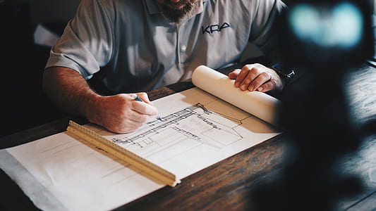 man sketching on pad using pen and ruler thumbnail