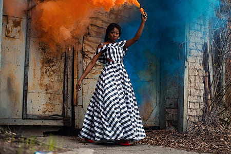 Woman in Black and White Plaid Dress Holding Torch thumbnail