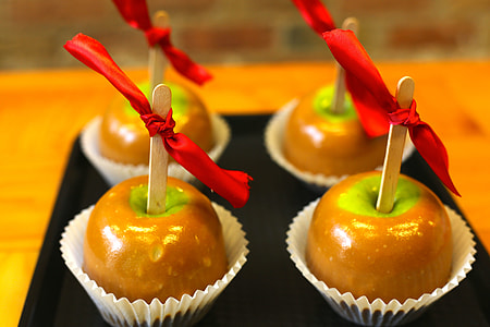 four green apple candies served on black tray thumbnail