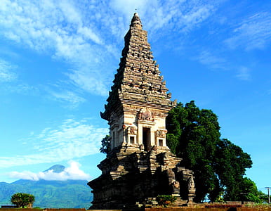 brown concrete temple near mountain at daytime thumbnail