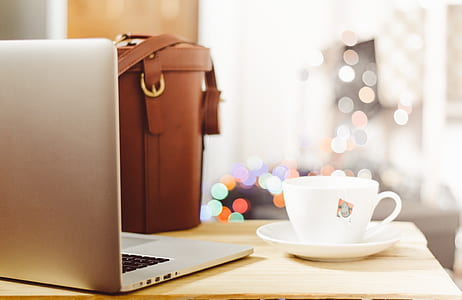 silver laptop computer beside white ceramic teacup with saucer thumbnail