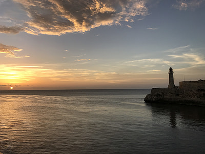 gray concrete lighthouse near body of water during daytime thumbnail