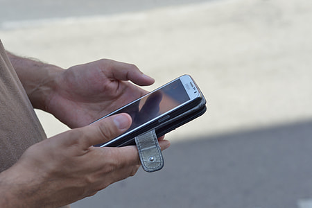 person holding white Samsung smartphone thumbnail