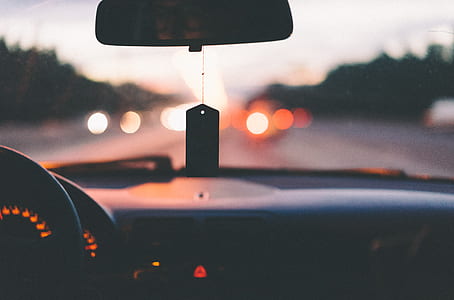 shallow focus photography of hanging ornament on rear view mirror thumbnail