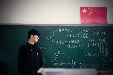 man standing near blackboard thumbnail