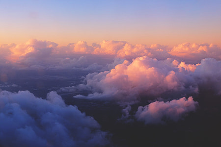 Aerial shot capturing the clouds in the sky at sunset thumbnail