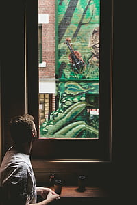 man looking at window thumbnail