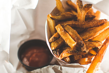fried food in white paper with saucer thumbnail