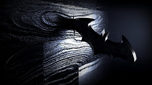 batman logo shaped blade on brown wooden surface thumbnail