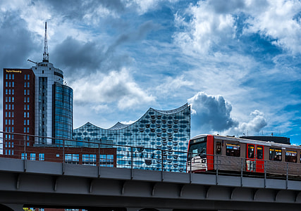 train near building under gray sky painting thumbnail