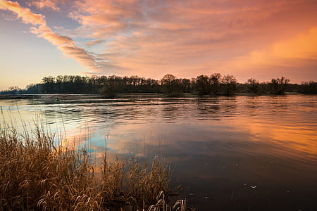 time lapse photography of lake under golden hour thumbnail