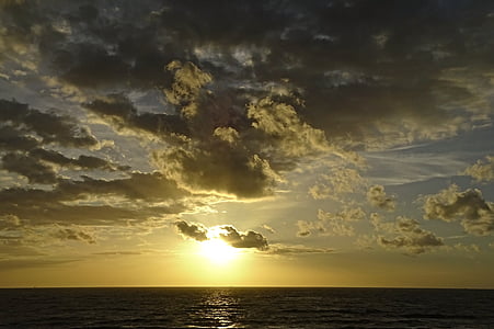 body of water at cloudy sky during sunrise thumbnail