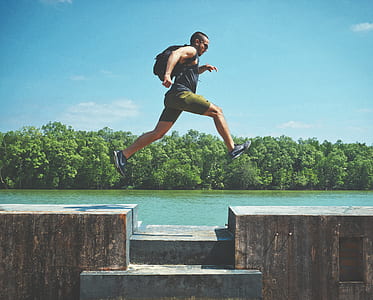 man jumping near river thumbnail
