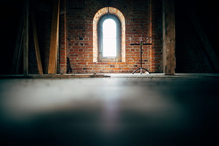 black music stand in front of brown brick wall thumbnail