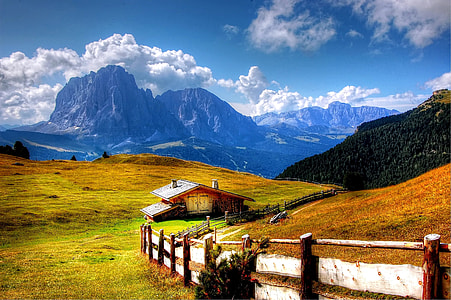 beige house surrounded by grass field thumbnail