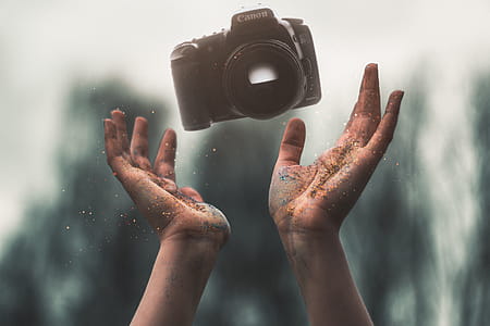 Selevtice Photography of Black Canon Dslr Camera Above Human Hands thumbnail