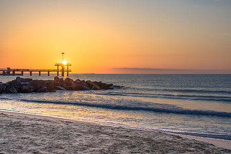 shore near rock formation during sunset thumbnail