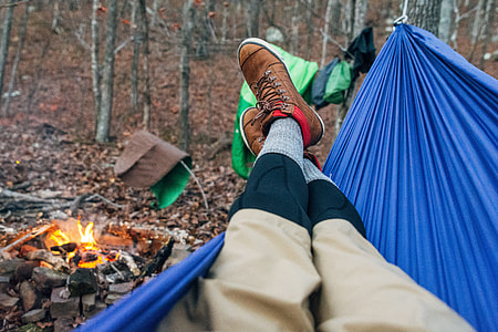 person lying on blue hammock thumbnail