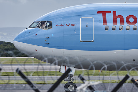view of blue and white airplane on runway thumbnail