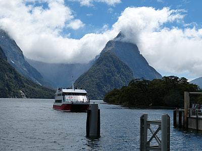 white cruise ship on body of water beside island during daytime thumbnail