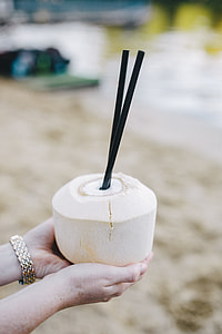 Female holding a fresh coconut thumbnail