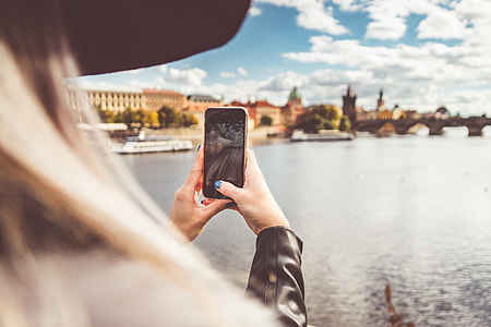 Young Woman Taking a Photo with Her iPhone thumbnail