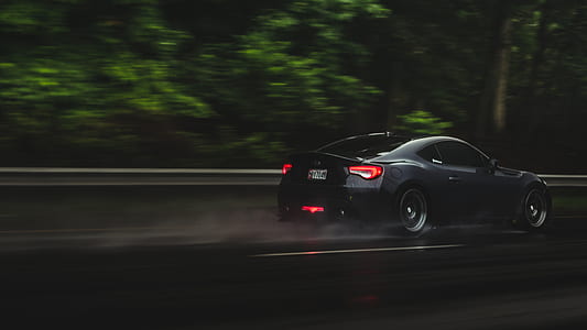 black coupe traveling on asphalt road thumbnail