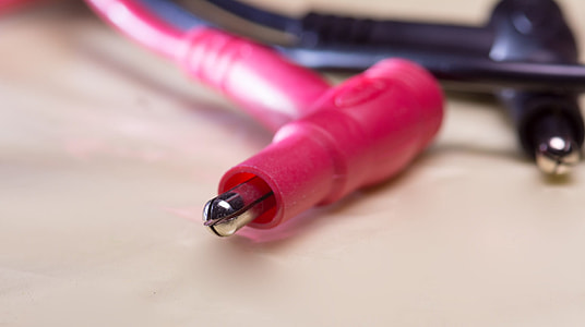 two red and black cords on beige surface thumbnail