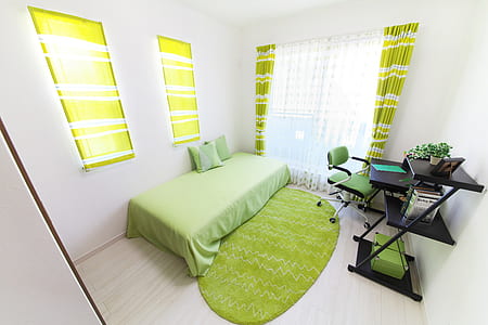 green bedding set near white wall thumbnail