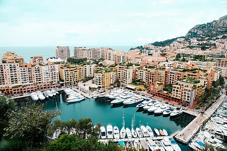 docked boats surrounded with buildings thumbnail