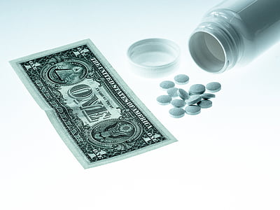 medicine tablets beside 1 US dollar banknote thumbnail