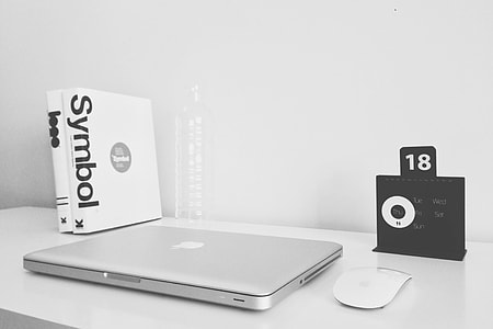 MacBook Pro and Apple Magic Mouse on white wooden table thumbnail