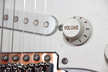 closeup photo of guitar body and tuner thumbnail