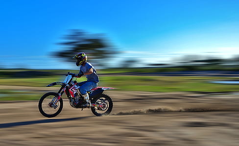 panning photography of man riding motocross dirt bike thumbnail