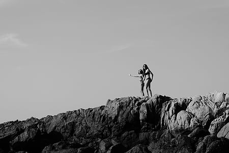two woman standing on mountain cliff thumbnail
