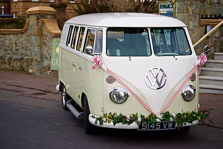 white and yellow Volkswagen T1 parked near gray concrete wall thumbnail