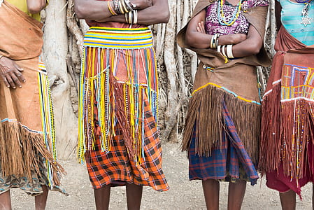 four women wearing assorted-color dresses thumbnail