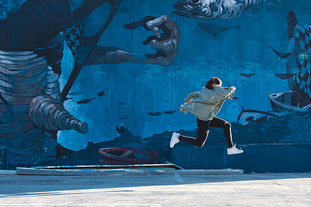 woman in black pants jumping under sunny sy thumbnail