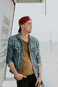 man standing near by lifeguard house looking on right thumbnail