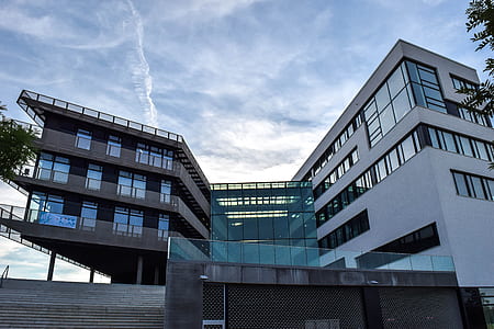 white and gray building under cloudy sky at daytime thumbnail