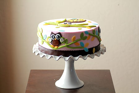 round pink and green icing cake on white cake dish thumbnail