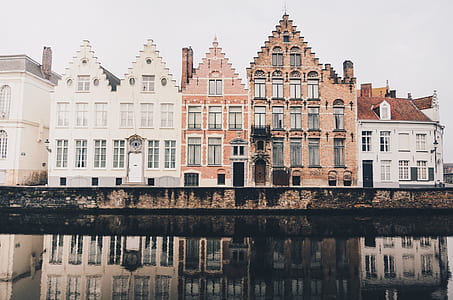 grey and white concrete building near body of water during daytime thumbnail