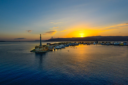 aerial photography of lighthouse on port thumbnail
