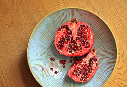 sliced red pomegranate on plate thumbnail