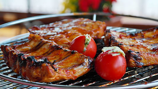 baby back ribs grilled on grilling tray with red tomatoes thumbnail