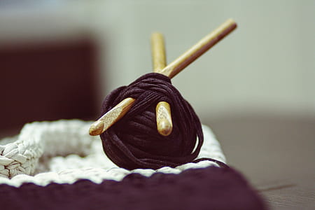 black yarn with stick on ground thumbnail